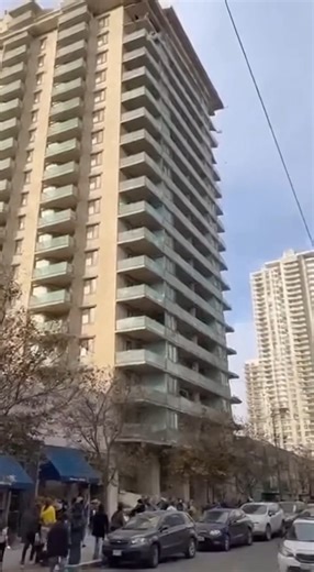 A tall apartment building is seen collapsing floor by floor from the top down, sending massive plumes of smoke and debris onto the street. #fblifestyle | Alone Feel