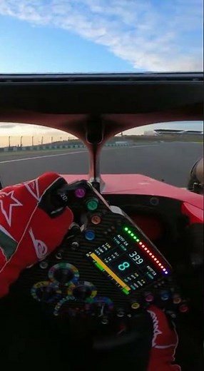 first person POV inside a Formula 1 cockpit driver steering through a high speed corner at 300 km/h
