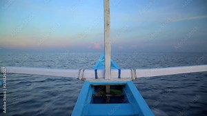 View of Outrigger canoe at speed racing across open ocean surface water Bali Indonesia South East Asia