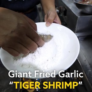 Giant TIGER SHRIMP!! Deep fried, then stir fried with a small mountain of garlic and chilies. Wat the full cooking process now!! 📍 Here's the restaurant ร้านอาหารกระบี่ น้องโจ๊ก อาหารใต้ ซีฟู๊ด (Nong Joke) in Krabi, Thailand | Migrationology