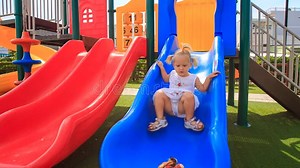 Little Girl with Hairtails Slides Down on Playground Stock Video - Video of childhood, outside: 57874545