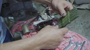 Mechanic repairing a part from a car chassis