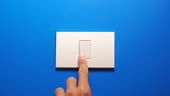 4k real time of People turning off light bulb switch on blue wall...