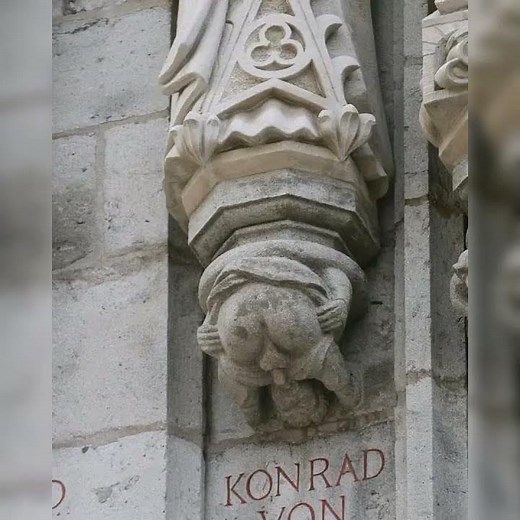 Grotesque male character performing auto-fellatio under the statue of the Archbishop Konrad ...