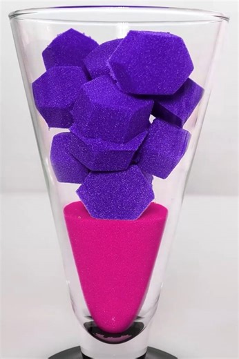 Purple hexagonal foam shapes in a colorful glass