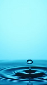 4X slow motion video Water droplets falling on water surface Water splashing