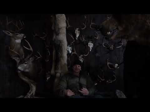 Two Children In A Deer Blind With Something Big On Two Legs Watching Them