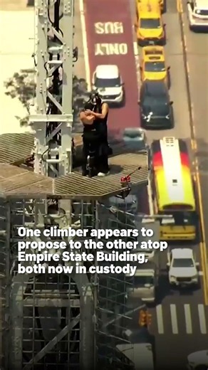 One climber appears to propose to the other atop Empire State Building, both now in custody