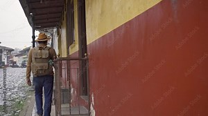 Young Mexican traveler with a backpack tours a magical town in Mexico