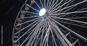 Slow motion medium wide 4K shot with forward tilt reveal motion of big spinning and illuminated ferris wheel with Santa clause animation at traditional Christmas market in Spikersuppa, in Oslo Norway. Stock Video