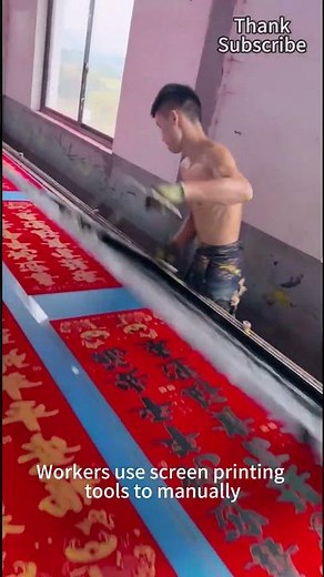 Workers use screen printing tools to manually scrape ink to make Spring Festival couplets