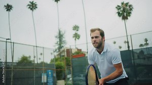 Tennis player jumping along court and spinning racket while match, playing professional tennis, strained game