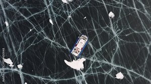 Hovercraft on the ice of lake Baikal in winter time. Clip. Aerial view of the air cushion vehicle on the thick ice of the frozen lake, sports transport and extreme concept.
