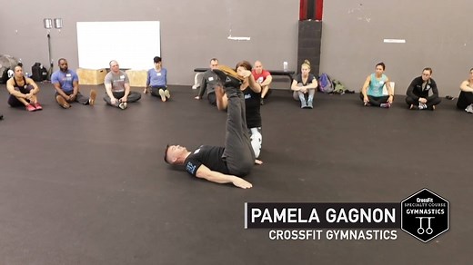 During the CrossFit Specialty Course: Gymnastics, participants learn to apply gymnastics principles in training themselves and others to increase strength development, core control and spatial awareness—all of which improve CrossFit performance. Pamela Gagnon shows participants how to achieve proper pike positioning from the ground. | CrossFit