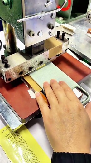 Embossing press stamps book spine—CICICTY foil aligns under firm hand