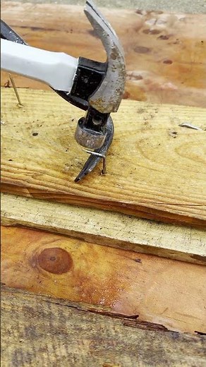 Using hammer and pry bar, the trick to flatten nails in construction sites