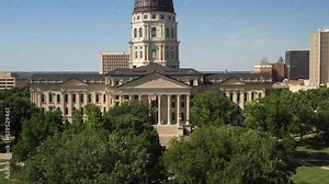 Kansas state capitol building in Topeka, Kansas with close up drone video moving up.