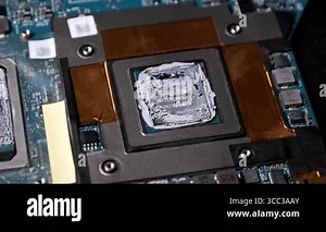Extreme close-up shot zooming into a laptops CPU die covered with thermal compound. The shot reveals the intricate details of the silicon chip and the surrounding motherboard components Stock Video Footage - Alamy