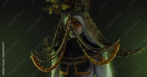 Portrait of Caucasian male with complex warrior floral make-up posing in creative lighting. Body painting fashion project. Model and property released