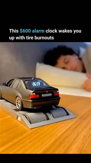 Furiouslytech on Instagram: "This device is a functioning dynamometer for 1:18 scale model cars that works as an alarm clock. The stand features motorized rollers that spin the wheels of a model BMW to simulate a real dyno test. A dynamometer is a machine that measures engine power by loading the wheels while the engine runs. This miniature version recreates that process using a small motor to spin the model car’s wheels. When the alarm time arrives, the system starts the car’s engine sound and 