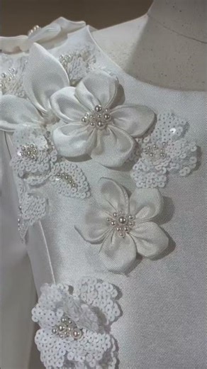 Hand making silk flowers and adding beading to them an already finished wedding gown is amazing