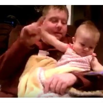Baby refuses to let go of daddy’s phone