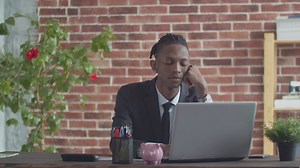 Young office worker looking bored at his desk - Free Stock Video