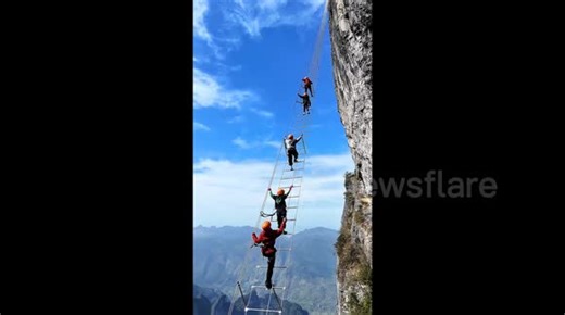 China's new dizzying cliff climb sees daredevils ascend 1,500 metres high via narrow ladder