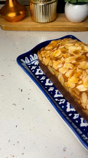 Almond Cake Ingredients: 2 eggs 1 cup Sugar 1/2 cup milk 1/2 cup oil 1 tsp baking powder 1/4 tsp baking soda 1 tsp vanilla essence 1 cup flour 2 tbsp almonds 1 tbsp semolina Almonds for topping Grease and line a 9 inch pan with parchment paper Preheat at 180C for 15 minutes Bake at 180C for 35-40 mins until a skewer comes our clean #almondcake #poundcake #cakelover #EasyRecipes #viral #baking #fblifestyle #homemade | GJ's Sweets & Savoury.