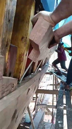 process of installing wooden planks for boats