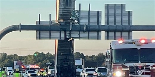 Trailer ripped off of semi by sign on highway