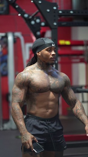 Muscular Individual Showcases Intricate Tattoos at Gym