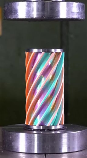 Nic Davis on Instagram: "Watch as a stunning neon-colored lattice rotor drum gets crushed by a hydraulic press. The metal ribs buckle and snap one by one, releasing gorgeous pearlescent slurry in a mesmerizing mechanical collapse."