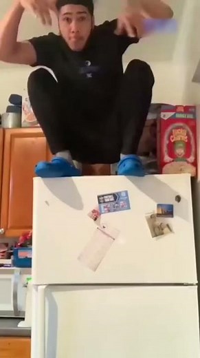 Guy Accidentally Falls Off Refrigerator While Trying to Make Poses on Top of it - 1299694