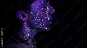 A beautiful young girl with makeup from ultraviolet paints smokes. Releases smoke from the mouth. Holiday of colors holly. Bright, colorful, festive coloring book. Fluorescent makeup on the face.