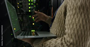 Server room, laptop and hands of technician coding or programming cyber security code or cloud computing online or on the web. Big data, database and person or programmer typing in a datacenter