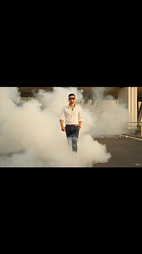 1. Open Google Flow Labs/VEO-2or3 2. Upload Your Image 3. Type the Prompt👇🎬 "Cinematic 8-second slow-motion video of a confident young man walking forward on a road through smoke and spark effects, same outfit and pose as the reference image — white t-shirt, black shirt open, black cargo pants, sunglasses. The background filled with white smoke and glowing orange sparks drifting around. Camera angle slightly low, tracking forward smoothly with natural motion blur and shallow depth of field. Re
