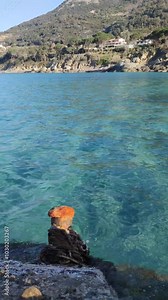 bollard on background of clear sea water. Bollard rope for fastening the mooring of ships, boats, ships Mooring bollard on the mole with sunset river transparent turquoise water surface Italy Livorno