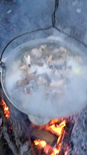 Outdoor Cooking: Meat in a Large Metal Pot