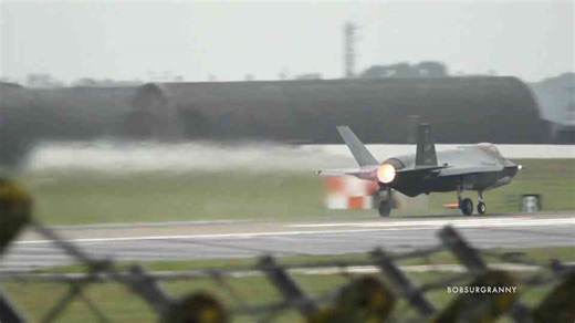 The second USAF fighters roar down a flooded runway