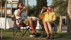 Happy family couple vacation, owner motor home, drinking beer cheers and relax, camping van driver smiling, tourist rent bus trailer for camping.