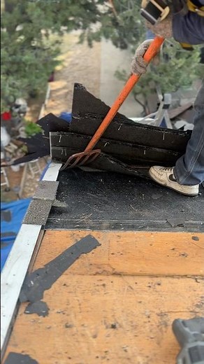 How roofers tear off old shingles using a roofing shovel! 🏡 #roofing #construction