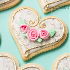 Pretty pink roses on marbled cookies! Get the supply list to make your own here: http://www.sweetambs.com/tutorial/marbled-cookies-with-gold-trim-and-pink-roses/ | SweetAmbs