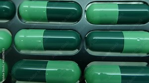 Capsules in macro view inside a capsule making machine. Capsule manufacturing process