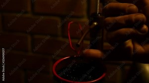 Home production of alcohol on flame fire. Alcohol distillation equipment liquid drips through the filter