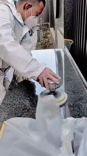 polishing large granite stone surfaces with a motorized buffer to achieve a high gloss and smooth