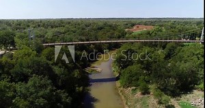 Aerial video of the Regency Bridge in Regency or Mullin Texas. This is a famous suspension bridge in Texas that crosses the Colorado river.