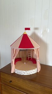 DIY Circus tent dollhouse 🎪🤹‍♂️ @genevavanderzei (IG) has turned a lamp into a dollhouse for her little ones using Spotlight fabrics! From layering triangles and fabric to adding bunting, flags, pom-poms, and cozy seating, every detail brought this whimsical vision to life! ✨ https://bit.ly/499U00q #SpotlightStores #ItsWhatYouMakeIt #Dollhouse #DIY | Spotlight