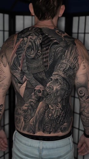 Some tattoos evolve. This one awakened. What started as a gigantic pharaoh attacking an Egyptian city — workers scrambling below, chaos everywhere — took a hard left turn after session one. Brandon hit me and said, “What if we add a shaman… Aztec / Mayan energy… someone fighting back?” I was all in. Before our next session, I ended up in Mexico with my family. My son got obsessed with the ancient death whistle. Jaguar. Dragon. But he wanted the skull one — the one everyone’s seen online. We trav