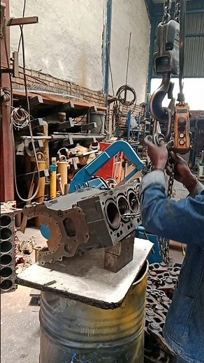 GETTING READY WITH STICK WELDING IN CRACKED CYLINDER FROM EXCAVATOR'S ENGINE BLOCK IN WORKSHOP
